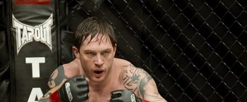 Movie still from “Warrior” (2011), directed by Gavin O'Connor – A person in a fighting stance; Close Up shot, Low angle