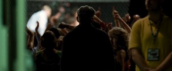 Movie still from “Warrior” (2011), directed by Gavin O'Connor – An old man is standing in front of a group of people; Medium shot, Over the shoulder angle