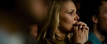 Movie still from “Warrior” (2011), directed by Gavin O'Connor – A person with her hand to her face; Close Up shot, Over the shoulder angle