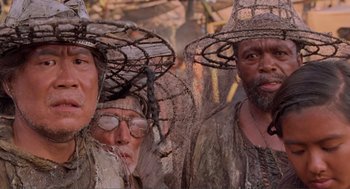Movie still from “Waterworld” (1995), directed by Kevin Reynolds – A group of men wearing hats and looking at the camera; Close Up shot, Low angle