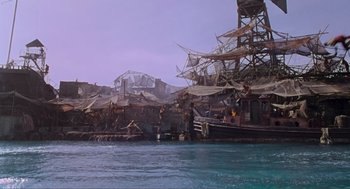 Movie still from “Waterworld” (1995), directed by Kevin Reynolds – A pirate ship in the middle of the water; Extreme Wide shot, High angle