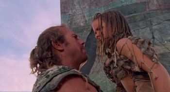 Movie still from “Waterworld” (1995), directed by Kevin Reynolds – A man and a girl are standing next to each other; Medium shot, Low angle