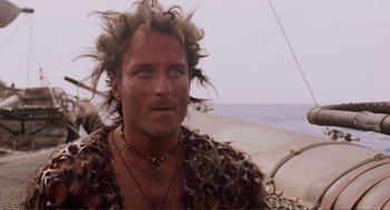 Movie still from “Waterworld” (1995), directed by Kevin Reynolds – A person wearing a costume; Close Up shot, Low angle