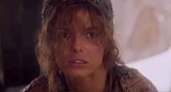 Movie still from “Waterworld” (1995), directed by Kevin Reynolds – A person wearing a hat and looking at the camera; Close Up shot, High angle