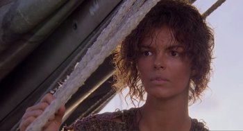 Movie still from “Waterworld” (1995), directed by Kevin Reynolds – A person holding a rope over their head; Close Up shot, Low angle