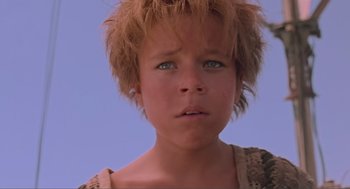 Movie still from “Waterworld” (1995), directed by Kevin Reynolds – A young boy's face with a blue sky background; Close Up shot, Low angle