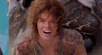 Movie still from “Waterworld” (1995), directed by Kevin Reynolds – A person with curly brown hair; Close Up shot, Low angle