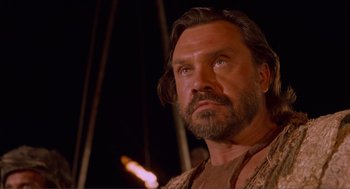 Movie still from “Waterworld” (1995), directed by Kevin Reynolds – A person with long hair and a beard; Close Up shot, Low angle