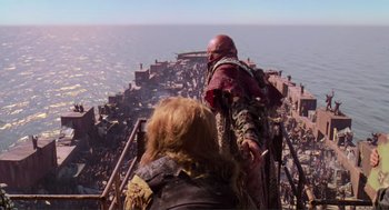 Movie still from “Waterworld” (1995), directed by Kevin Reynolds – Two people standing on the side of a boat; Extreme Wide shot, High angle
