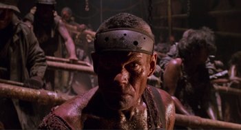 Movie still from “Waterworld” (1995), directed by Kevin Reynolds – A person with a helmet on; Close Up shot, Low angle