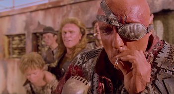 Movie still from “Waterworld” (1995), directed by Kevin Reynolds – A group of people dressed up like pirates; Close Up shot, Low angle