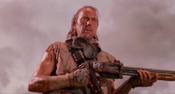 Movie still from “Waterworld” (1995), directed by Kevin Reynolds – A man with a gun in his hands; Close Up shot, Low angle