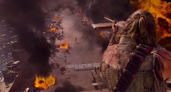 Movie still from “Waterworld” (1995), directed by Kevin Reynolds – An aerial view of a burning area with a helicopter in the foreground; Wide shot, Overhead angle