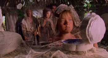 Movie still from “Waterworld” (1995), directed by Kevin Reynolds – A young girl in a hat and a group of people; Close Up shot, Low angle