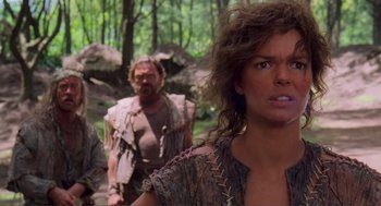 Movie still from “Waterworld” (1995), directed by Kevin Reynolds – A group of people walking through a forest; Close Up shot, Over the shoulder angle