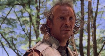 Movie still from “Waterworld” (1995), directed by Kevin Reynolds – A person with long hair; Close Up shot, Low angle