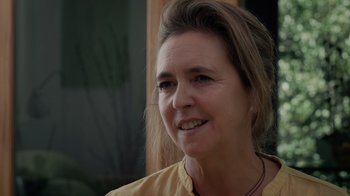 Movie still from “We Feed People” (2022), directed by Ron Howard – A person wearing a yellow shirt; Close Up shot, Over the shoulder angle