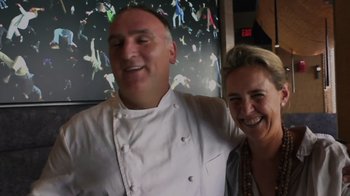 Movie still from “We Feed People” (2022), directed by Ron Howard – A man and a woman posing for a picture in a restaurant; Medium shot, Low angle