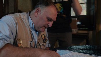 Movie still from “We Feed People” (2022), directed by Ron Howard – A man looking down at a map in front of him; Close Up shot, Over the shoulder angle