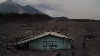 Movie still from “We Feed People” (2022), directed by Ron Howard – An old shack in the middle of a dirt field; Extreme Wide shot, High angle