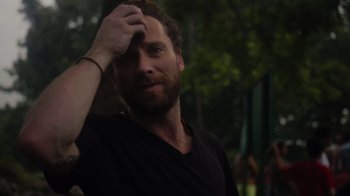 Movie still from “We Feed People” (2022), directed by Ron Howard – A man with a beard is holding his hand up to his forehead; Close Up shot, Over the shoulder angle