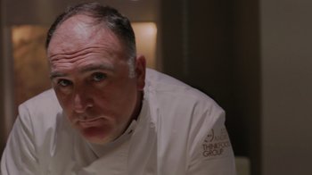 Movie still from “We Feed People” (2022), directed by Ron Howard – A person wearing a chef's outfit; Close Up shot, Over the shoulder angle