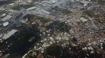 Movie still from “We Feed People” (2022), directed by Ron Howard – An aerial view of a city that has been devastated by a flood; Extreme Wide shot, Overhead angle