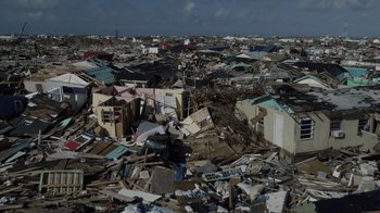Movie still from “We Feed People” (2022), directed by Ron Howard – A view of a city that has been hit by a tornado; Extreme Wide shot, High angle