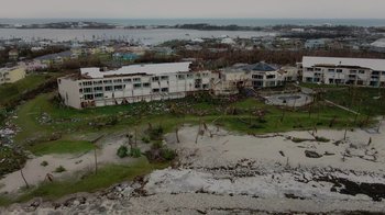 Movie still from “We Feed People” (2022), directed by Ron Howard – An aerial view of a flooded area with houses and trees; Extreme Wide shot, High angle