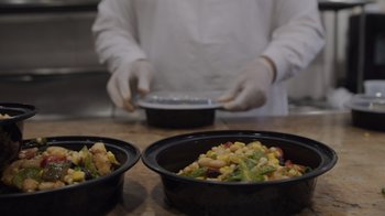 Movie still from “We Feed People” (2022), directed by Ron Howard – A person in a kitchen preparing a meal; Extreme Close Up shot, High angle