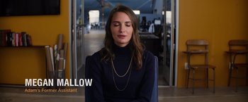 Movie still from “WeWork: Or the Making and Breaking of a $47 Billion Unicorn” (2021), directed by Jed Rothstein – A woman sitting down with her eyes closed; Medium shot, High angle