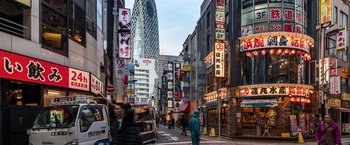 A busy city street with a lot of signs on the side