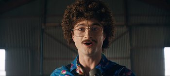 Movie still from “Weird: The Al Yankovic Story” (2022), directed by Eric Appel – A man with a curly hair and a mustache; Close Up shot, High angle