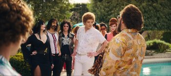 Movie still from “Weird: The Al Yankovic Story” (2022), directed by Eric Appel – A group of people standing in a line; Wide shot, Over the shoulder angle