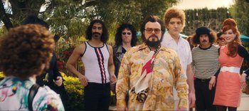 Movie still from “Weird: The Al Yankovic Story” (2022), directed by Eric Appel – A group of men standing next to each other; Medium shot, Low angle