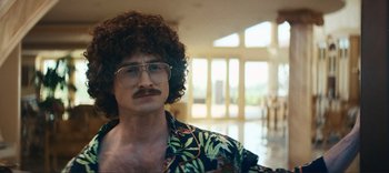Movie still from “Weird: The Al Yankovic Story” (2022), directed by Eric Appel – A man in a hawaiian shirt and glasses; Close Up shot, Over the shoulder angle