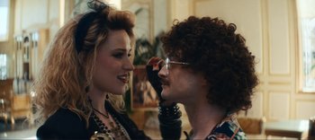 Movie still from “Weird: The Al Yankovic Story” (2022), directed by Eric Appel – A man and a woman looking at each other; Close Up shot, Over the shoulder angle