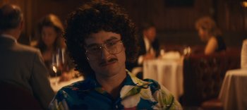 Movie still from “Weird: The Al Yankovic Story” (2022), directed by Eric Appel – A man in a floral shirt and glasses; Close Up shot, Over the shoulder angle