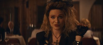 Movie still from “Weird: The Al Yankovic Story” (2022), directed by Eric Appel – A person wearing a hat; Close Up shot, Over the shoulder angle