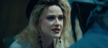 Movie still from “Weird: The Al Yankovic Story” (2022), directed by Eric Appel – A person with long hair; Close Up shot, Over the shoulder angle