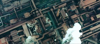 Movie still from “Weird: The Al Yankovic Story” (2022), directed by Eric Appel – An aerial view of a plant with pipes and pipes of various sizes; Extreme Wide shot, Overhead angle