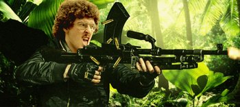 Movie still from “Weird: The Al Yankovic Story” (2022), directed by Eric Appel – A man holding a rifle in the woods; Close Up shot, Low angle