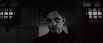 Movie still from “Werewolf by Night” (2022), directed by Michael Giacchino – A black and white photo of a man in a suit; Close Up shot, Low angle