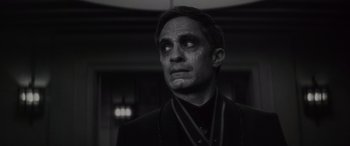 Movie still from “Werewolf by Night” (2022), directed by Michael Giacchino – A black and white photo of a man with tears in his eyes; Close Up shot, Over the shoulder angle