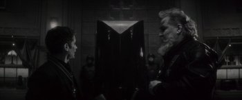 Movie still from “Werewolf by Night” (2022), directed by Michael Giacchino – Two people are facing each other in front of a mirror; Medium shot, Over the shoulder angle