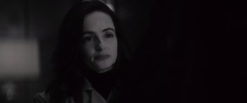 Movie still from “Werewolf by Night” (2022), directed by Michael Giacchino – A black - and - white photo of a woman looking at the camera; Close Up shot, Over the shoulder angle