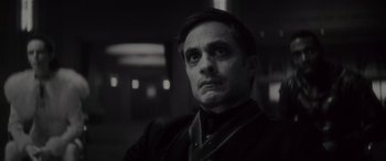 Movie still from “Werewolf by Night” (2022), directed by Michael Giacchino – A black and white photo of a man in a suit; Close Up shot, Low angle