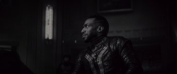 Movie still from “Werewolf by Night” (2022), directed by Michael Giacchino – A black and white photo of a man looking up at the sky; Close Up shot, Over the shoulder angle