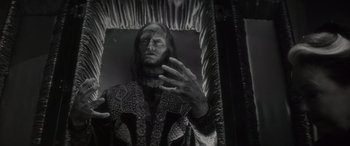 Movie still from “Werewolf by Night” (2022), directed by Michael Giacchino – A black - and - white photo of a man in a suit; Medium shot, Low angle