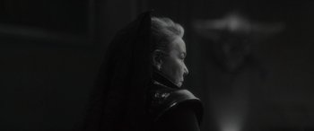 Movie still from “Werewolf by Night” (2022), directed by Michael Giacchino – An older woman wearing a black dress and a black veil; Close Up shot, Over the shoulder angle